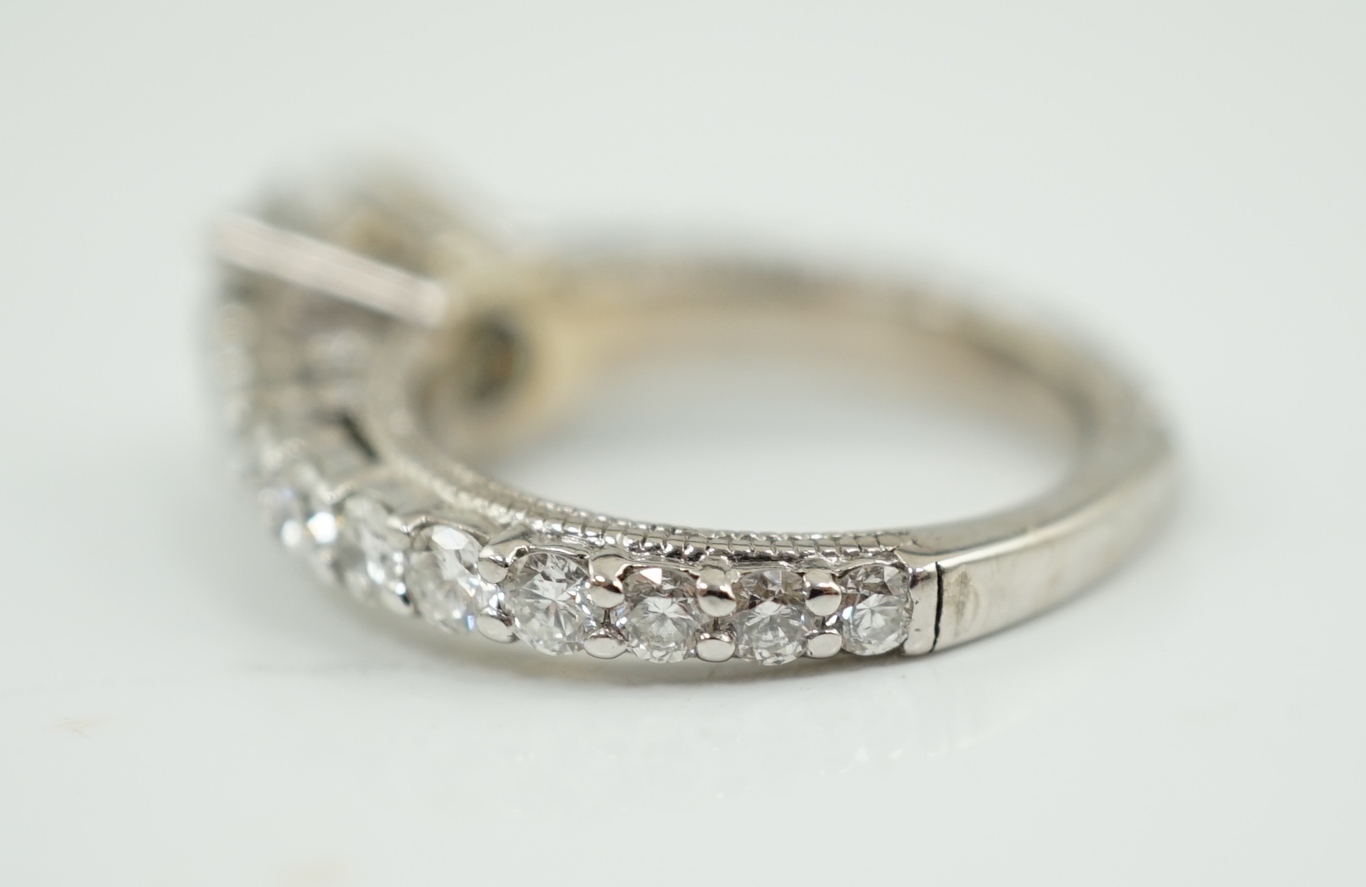 A modern 18ct white gold and single stone diamond set ring, with twenty eight graduated diamond set shank and setting